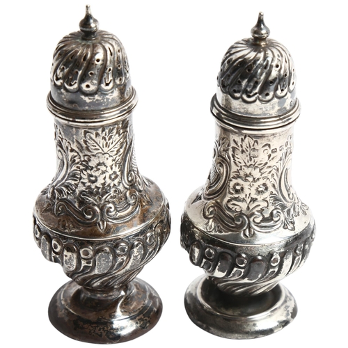 1300 - A pair of Victorian embossed and fluted pepperettes, hallmarks for Birmingham 1889