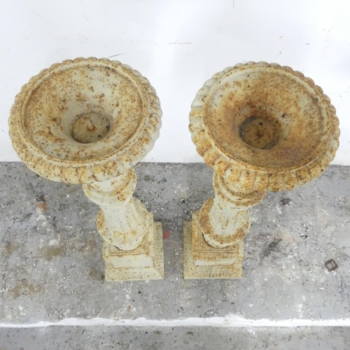 2668 - A pair of cast iron Campana style pricket candlesticks. 20x71cm.