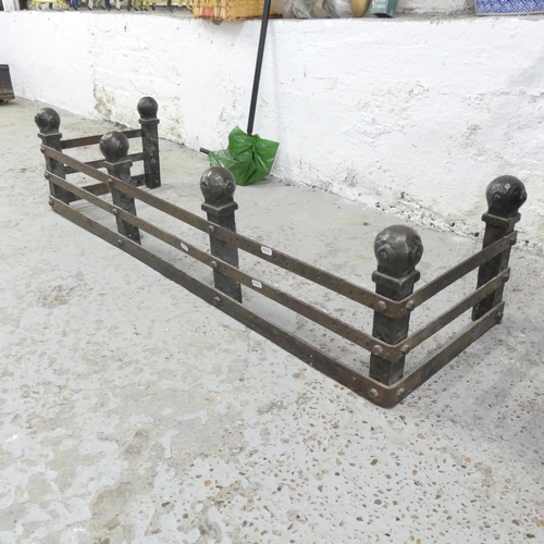 2673 - A cast iron Arts & Crafts style fire surround with ball finials. 122x28x38cm.