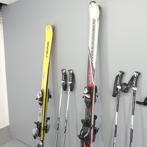 2680 - Two pairs of skis, by Head and Rossignol, and three pairs of poles, with carrying bags.