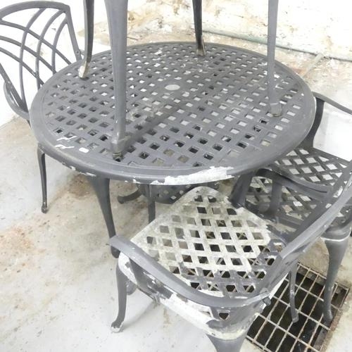 2685 - A painted metal circular garden table, 90xx72cm, and four matching chairs.