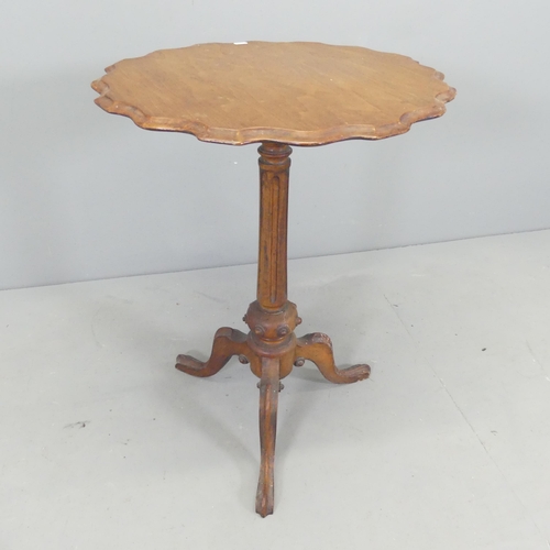 2688 - A Victorian mahogany circular occasional table with pie-crust edge. 53x71cm.