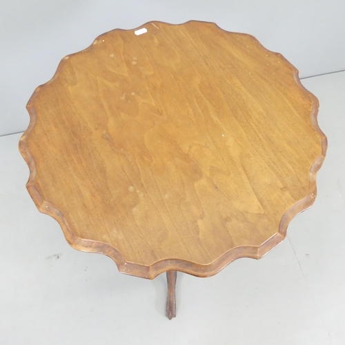 2688 - A Victorian mahogany circular occasional table with pie-crust edge. 53x71cm.