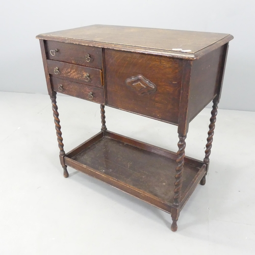 2630 - An early 20th century oak two-tier sewing table, with lifting lid, three drawers and barley twist su... 