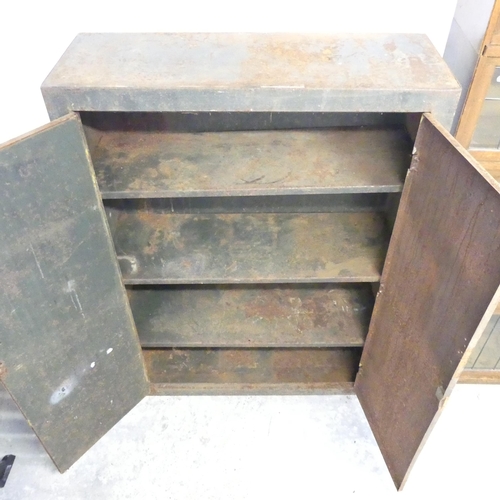 2633 - A Vintage industrial painted metal two door cabinet, with shelf fitted interior. 86x120x32cm.