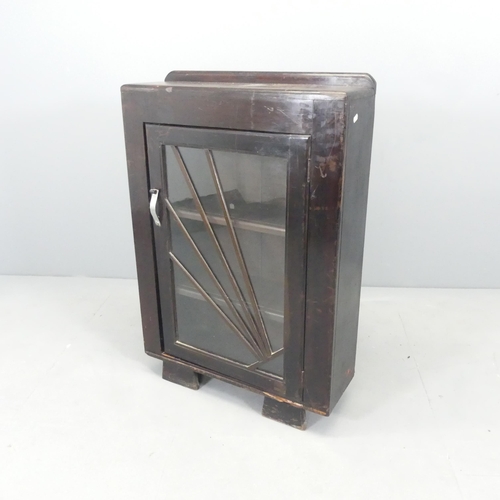 2637 - An Art Deco stained pine bookcase, with raised back, single glazed door and three fixed shelves. 64x... 