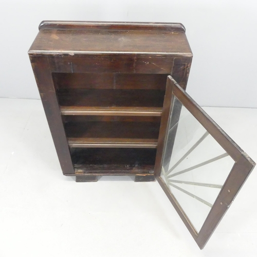 2637 - An Art Deco stained pine bookcase, with raised back, single glazed door and three fixed shelves. 64x... 