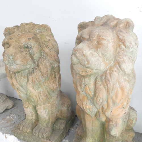 2647 - A pair of terracotta lion statues. 34x80x38cm.