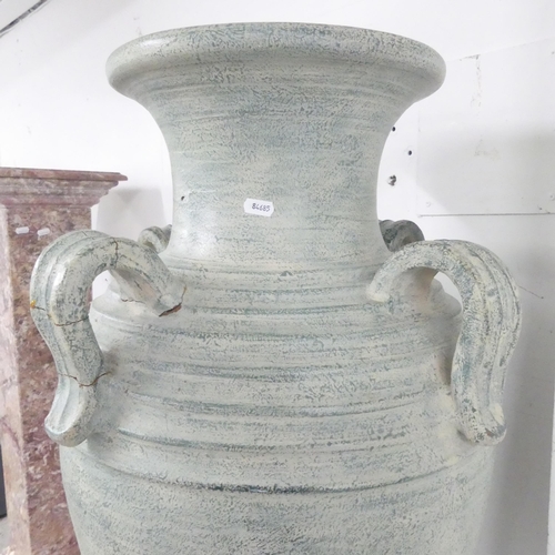 2650 - A large terracotta garden urn, with four handles. 50x102cm.