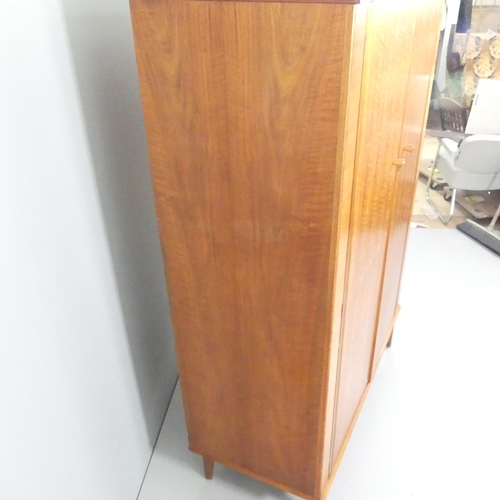 2098 - ALFRED COX - a mid-century teak and satin walnut two-door wardrobe, with rail fitted interior and ma... 