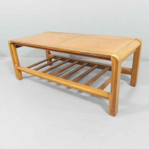 2104 - REMPLOY - A mid-century teak two-tier coffee table, the extending leaves revealing a copper inset pa... 