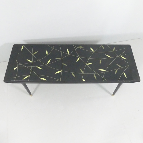 2109 - A contemporary black lacquered coffee table with inset glass panel. 130x42x46cm.