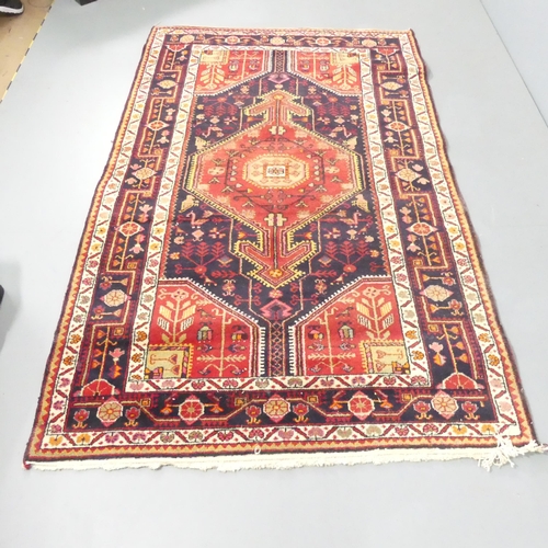 2131 - A red-ground Toserkan Hamadan rug. 228x140cm.