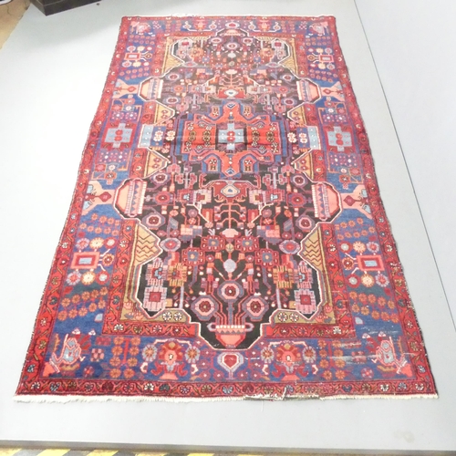 2132 - A red-ground Persian Nahavand carpet. 293x145cm.