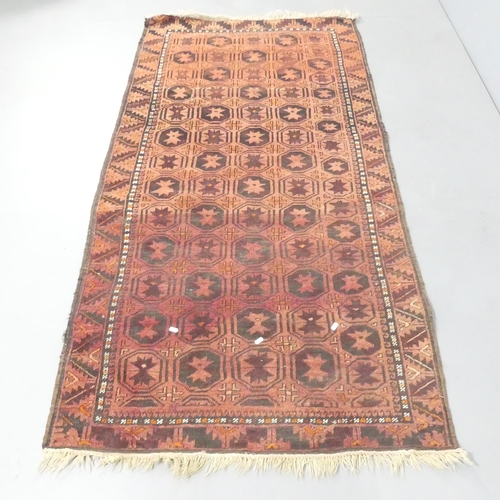 2134 - A red-ground Tekke rug. 202x106cm.