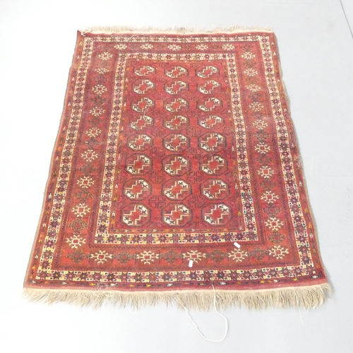 2135 - A red-ground Tekke rug. 144x112cm