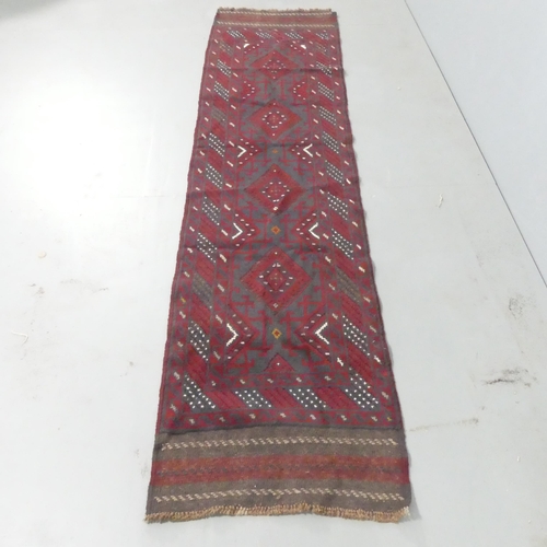 2141 - A red-ground Meshwani runner. 250x61cm.