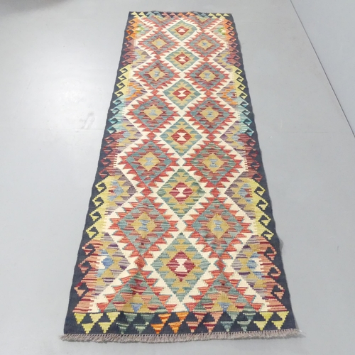 2145 - A Chobi Kilim runner. 243x80cm.