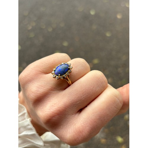 1111 - A modern 18ct gold black opal and diamond oval cluster ring, set with oval cabochon opal and modern ... 