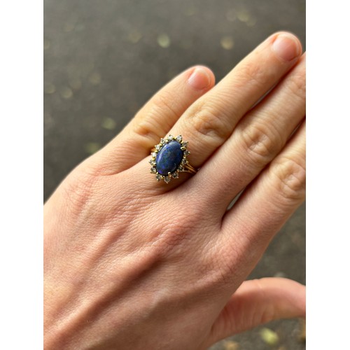 1111 - A modern 18ct gold black opal and diamond oval cluster ring, set with oval cabochon opal and modern ... 