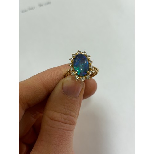 1111 - A modern 18ct gold black opal and diamond oval cluster ring, set with oval cabochon opal and modern ... 