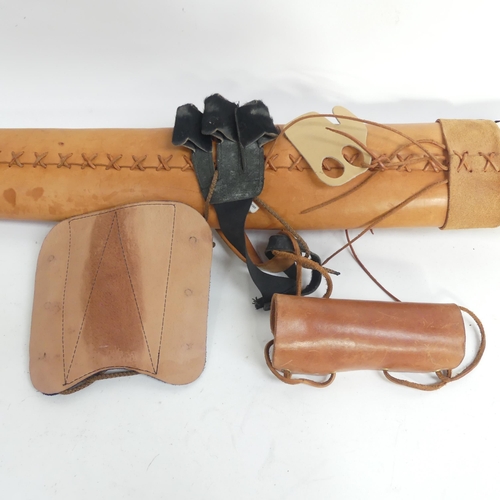 204 - A vegetable tanned leather quiver, with arm guards and finger guards, with 20 wooden arrows, all bul... 