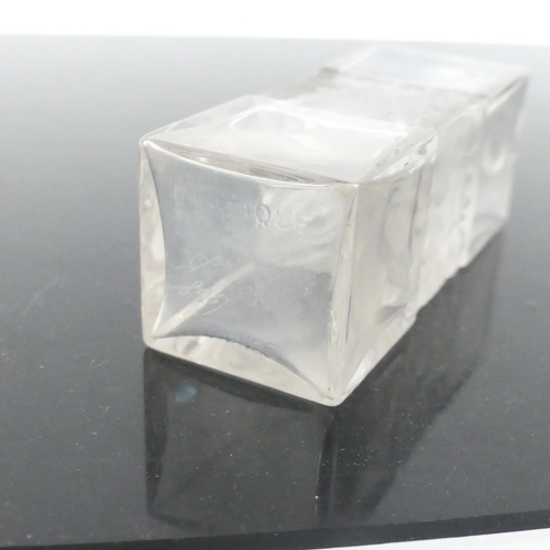 487 - R LALIQUE FRANCE - a rectangular scent bottle and stopper, having a moulded child and tree design ce... 