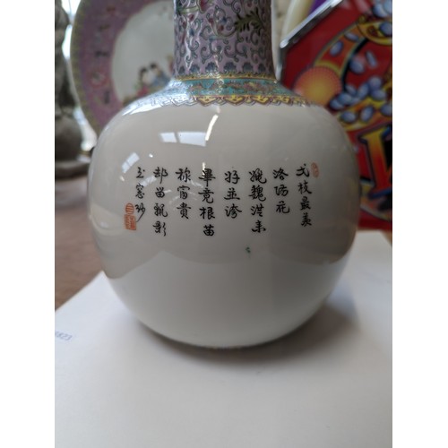 28 - A large Chinese famille rose bottle vase, enamel decoration depicting a prowling cat, on carved hard... 