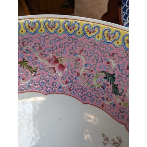 26 - A large Chinese famille rose charger, enamel decoration decorated with figures, diameter 41cm, on st... 