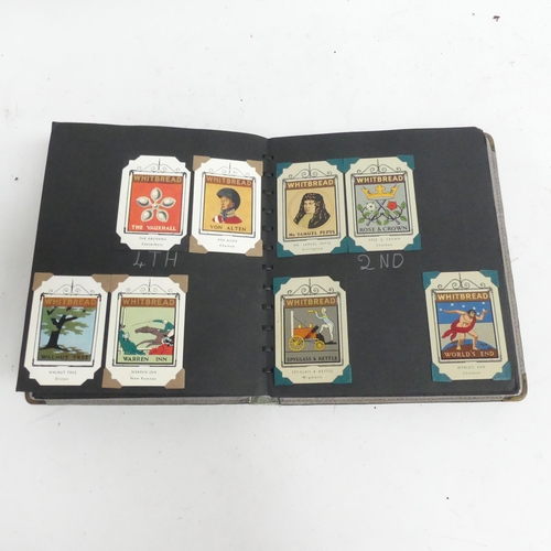 97 - An album of Whitbread tin and card inn cards