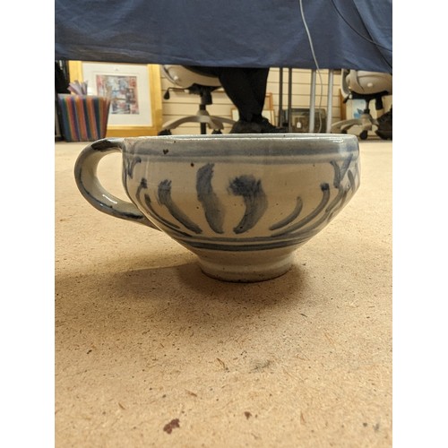 714 - 3 pieces of Studio pottery, Seth Cardew cup and saucer and a large Abuja pottery tankard, both with ... 