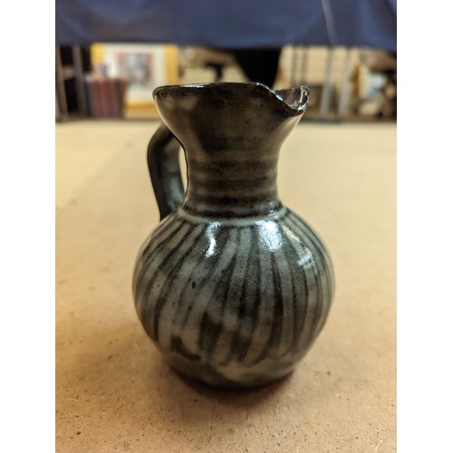 714 - 3 pieces of Studio pottery, Seth Cardew cup and saucer and a large Abuja pottery tankard, both with ... 