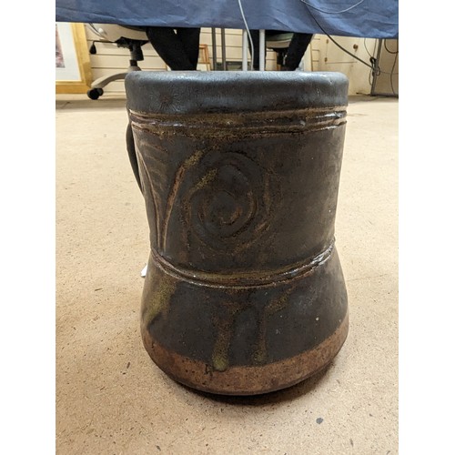 714 - 3 pieces of Studio pottery, Seth Cardew cup and saucer and a large Abuja pottery tankard, both with ... 