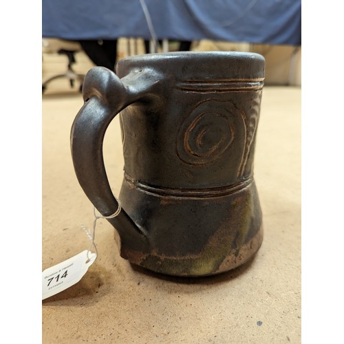 714 - 3 pieces of Studio pottery, Seth Cardew cup and saucer and a large Abuja pottery tankard, both with ... 