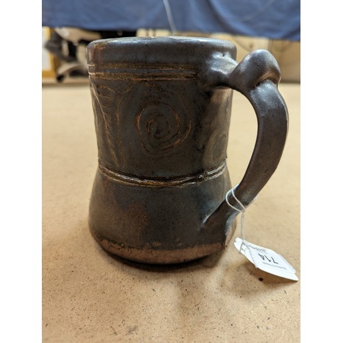 714 - 3 pieces of Studio pottery, Seth Cardew cup and saucer and a large Abuja pottery tankard, both with ... 