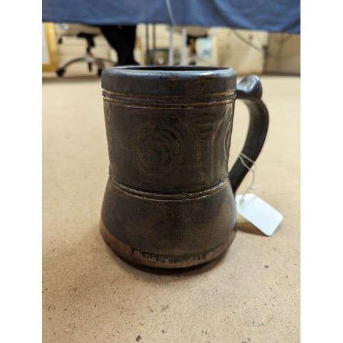 714 - 3 pieces of Studio pottery, Seth Cardew cup and saucer and a large Abuja pottery tankard, both with ... 