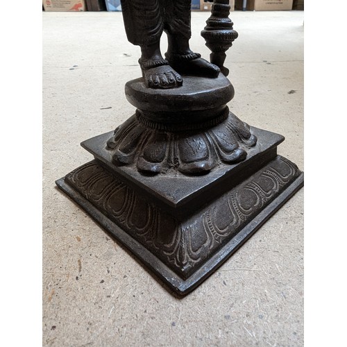 564 - A bronze sculpture of Indian deity Vishnu, on a stand with lotus leaf decoration, H31cm