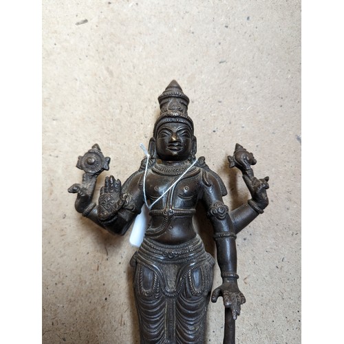 564 - A bronze sculpture of Indian deity Vishnu, on a stand with lotus leaf decoration, H31cm