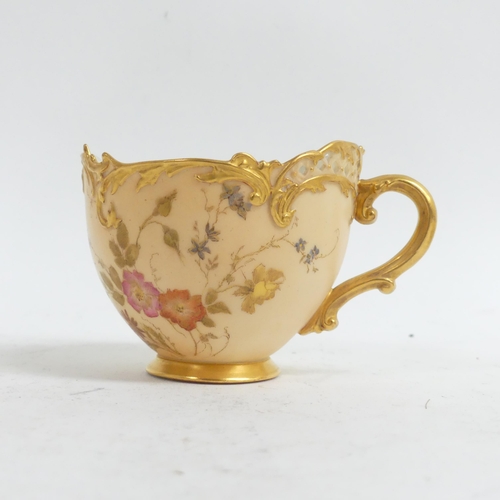 1075 - A Royal Worcester Blush Ivory Empress tea cup and saucer,  decorated with sprays of flowers, with pi... 