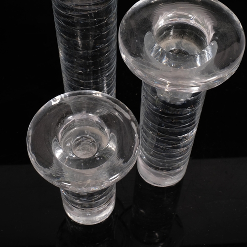 120 - Kosta Boda, Sweden, a set of 3 graduated solid glass candlesticks, with labels, tallest 30cm