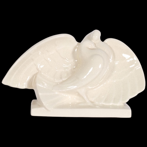 135 - A early/mid 20th century ceramic sculpture of doves, makers mark on reverse WH, indistinct 