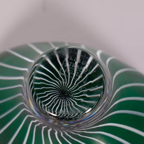 168 - Vicke Lindstrand for Kosta, a small oval shaped bowl in dark green glass with white
milk glass cane ... 