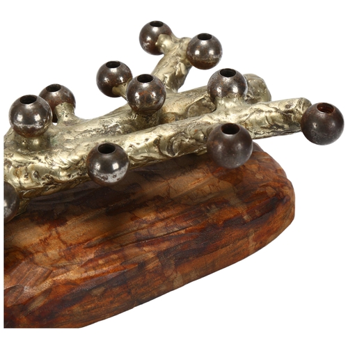 17 - A mid 20th century organic form taper holder, steel log on carved wood base, length 20cm