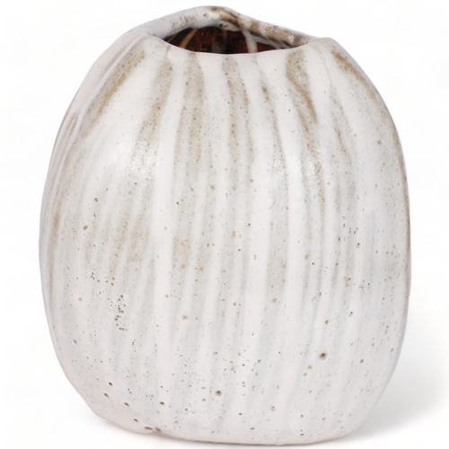 183 - Yuriko Hill (1950-2013), a coconut shaped studio pottery vase with cream glaze, height 16cm