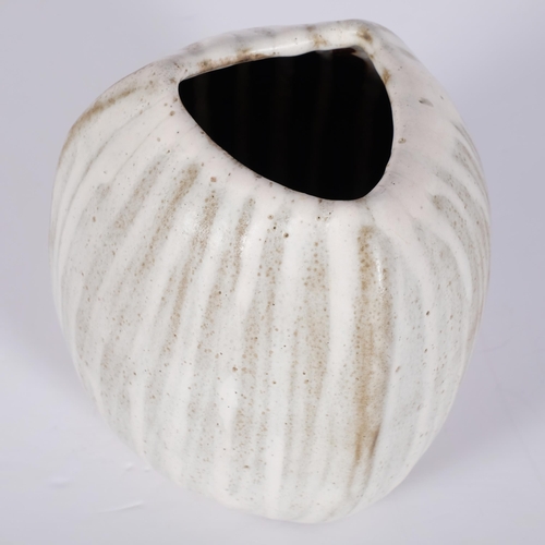 183 - Yuriko Hill (1950-2013), a coconut shaped studio pottery vase with cream glaze, height 16cm