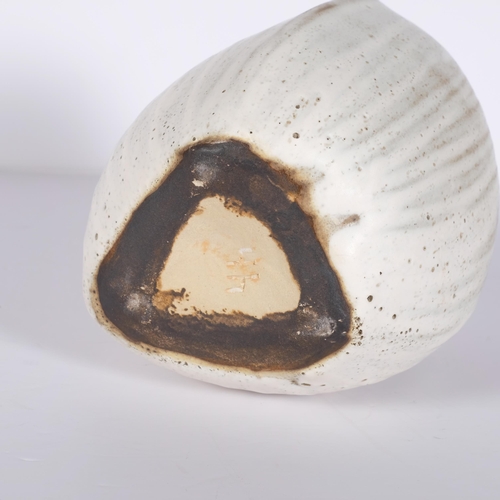 183 - Yuriko Hill (1950-2013), a coconut shaped studio pottery vase with cream glaze, height 16cm