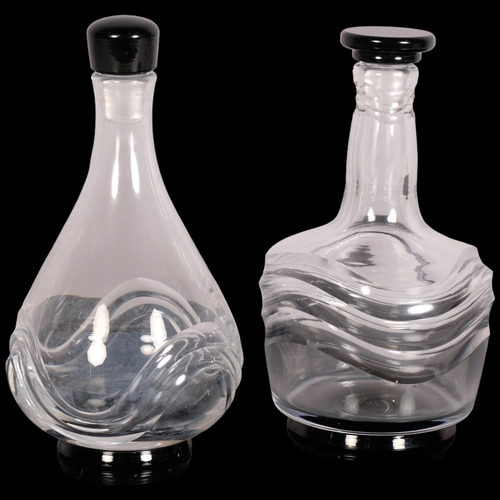 222 - Simon Gate for Orrefors, two wave pattern decanters with black glass foot and stopper, 1920s/30s des... 