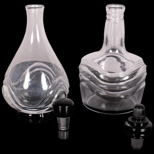 222 - Simon Gate for Orrefors, two wave pattern decanters with black glass foot and stopper, 1920s/30s des... 