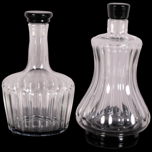 223 - Simon Gate for Orrefors, two fluted pattern decanters with black glass foot and stopper, 1920s/30s d... 