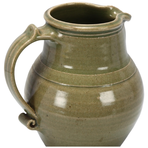 54 - Leach Pottery, St Ives, a celadon glazed jug with scrolled handle, pottery stamp to base, 18.5cm